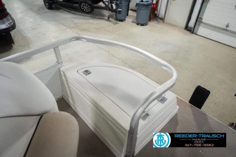 Slide: The Image of 1999 Landau DX24 boat interior with storage compartment and railing. - 22
