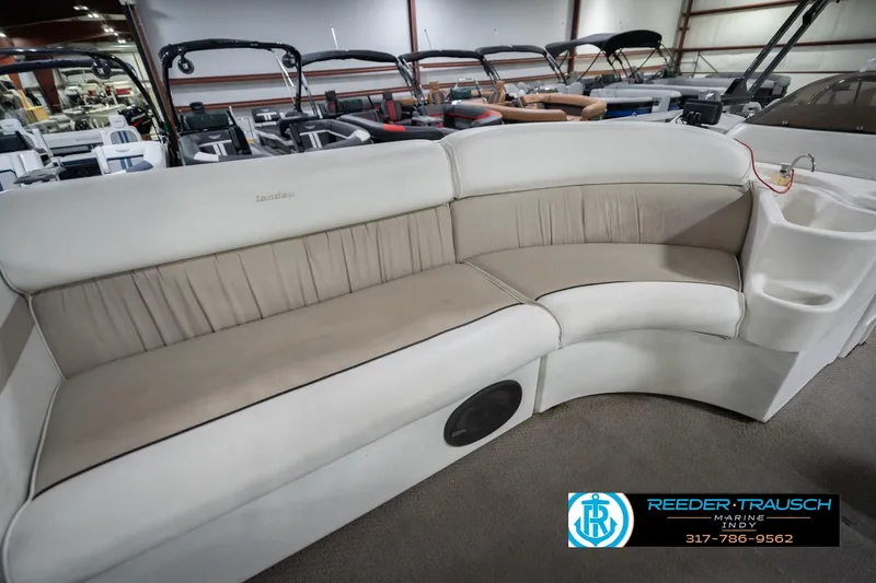 Slide: The Image of 1999 Landau DX24 boat interior with beige seating in showroom. - 25