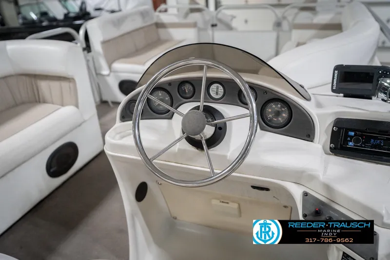 Slide: The Image of 1999 Landau DX24 boat dashboard with steering wheel and gauges. - 30