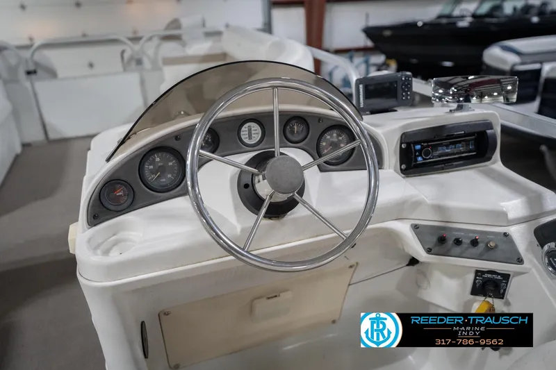 Slide: The Image of 1999 Landau DX24 boat dashboard with steering wheel and control panel. - 31