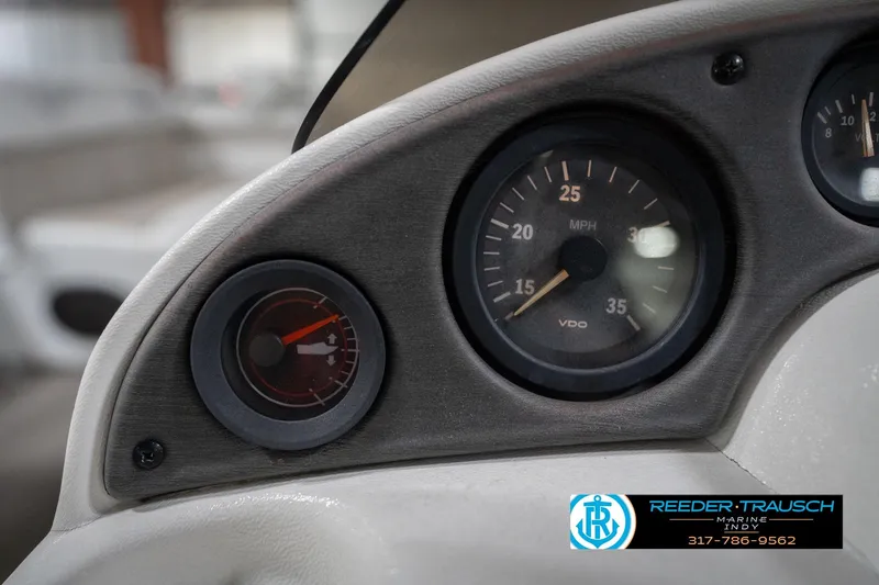 Slide: The Image of Dashboard of a 1999 Landau DX24 boat with speedometer and fuel gauge. - 33