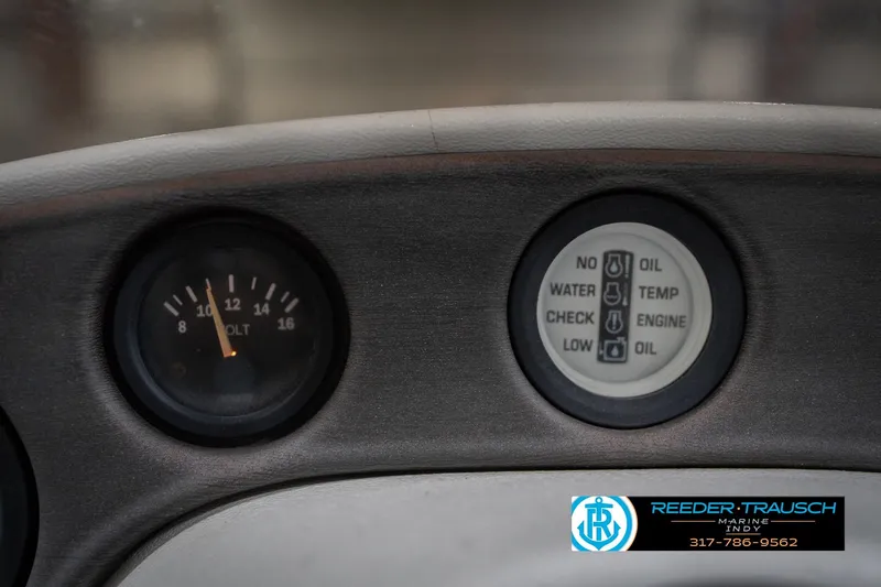 Slide: The Image of 1999 Landau DX24 dashboard gauges with voltmeter and indicator lights. - 34