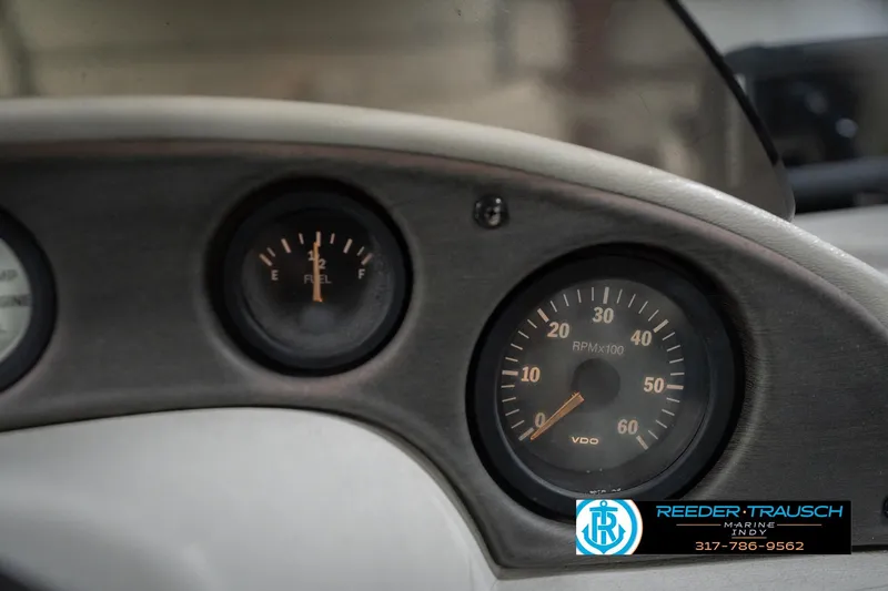 Slide: The Image of Dashboard of a 1999 Landau DX24 with fuel and RPM gauges. - 35