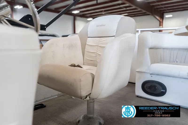 Slide: The Image of 1999 Landau DX24 boat interior with worn captain's chair and visible speaker. - 39