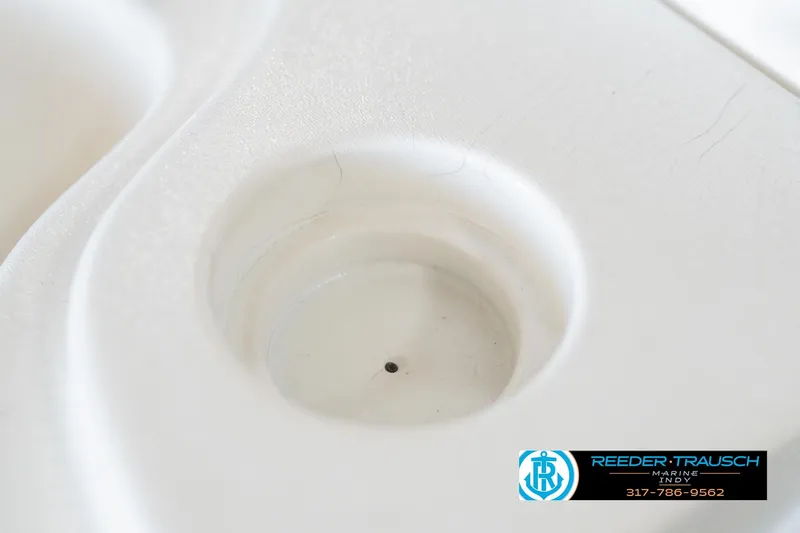 Slide: The Image of Close-up of a 1999 Landau DX24 boat cup holder with Reeder-Trausch Marine logo. - 47