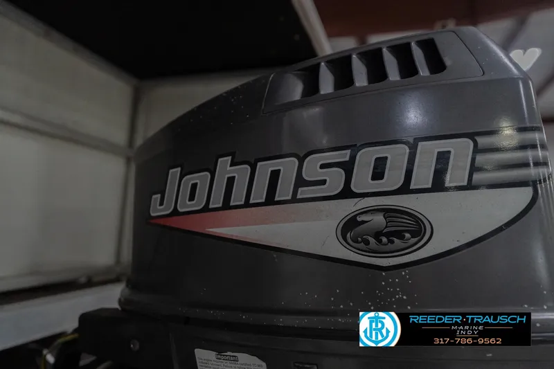 Slide: The Image of 1999 Landau DX24 with Johnson outboard motor, Reeder-Trausch Marine logo visible. - 51