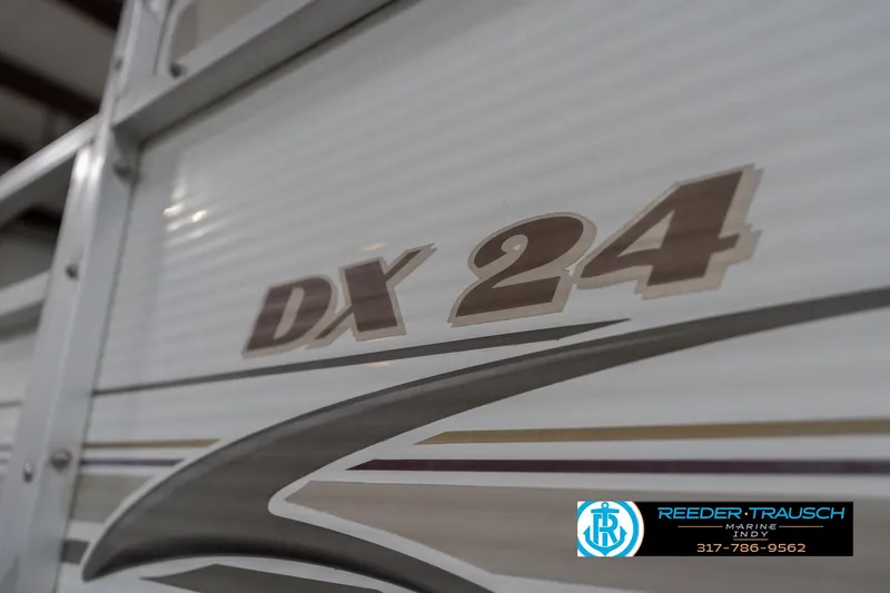 Slide: The Image of 1999 Landau DX24 boat with logo and design details. - 55