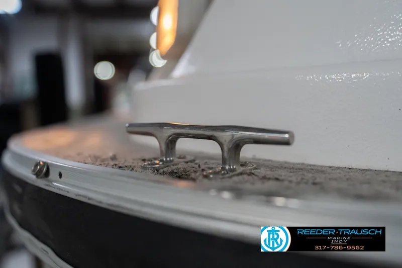 Slide: The Image of Close-up of a 1999 Landau DX24 boat cleat with Reeder-Trausch Marine logo. - 59