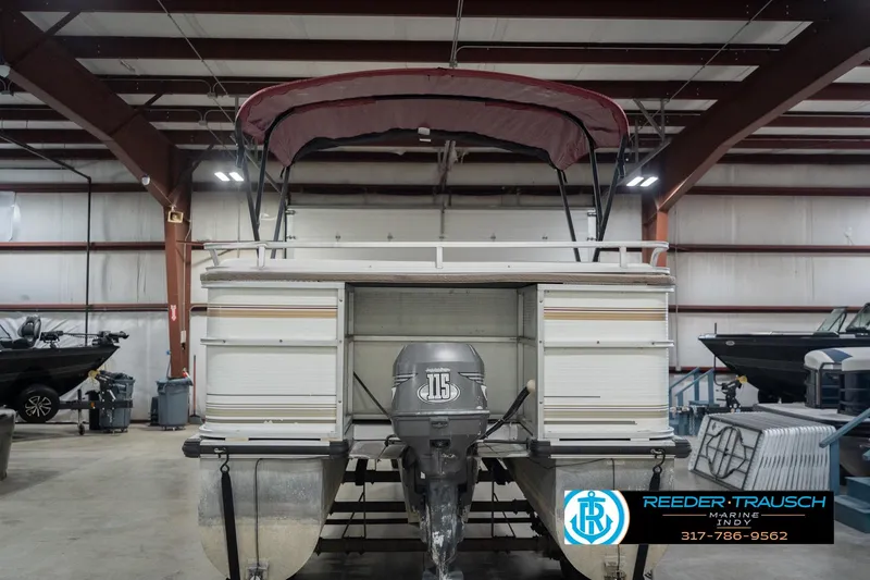 Slide: The Image of 1999 Landau DX24 pontoon boat with canopy in indoor storage facility. - 9