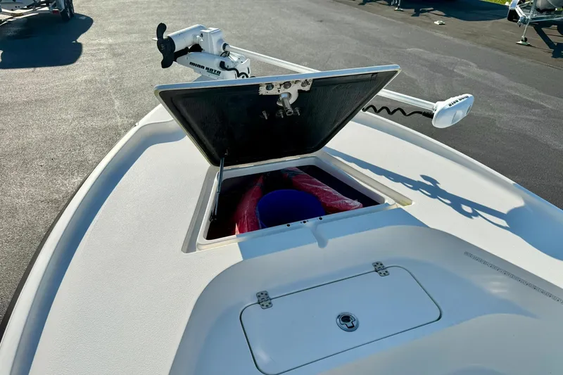 Slide: The Image of 2022 Key West 188 Bay Reef boat with open storage compartment and trolling motor. - 12