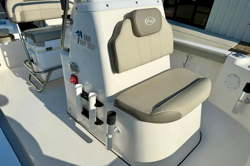 Slide: The Image of 2022 Key West 188 Bay Reef boat interior with cushioned seating and storage compartments. - 16
