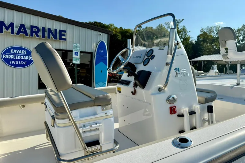Slide: The Image of 2022 Key West 188 Bay Reef boat at marine dealership, featuring console and seating. - 18