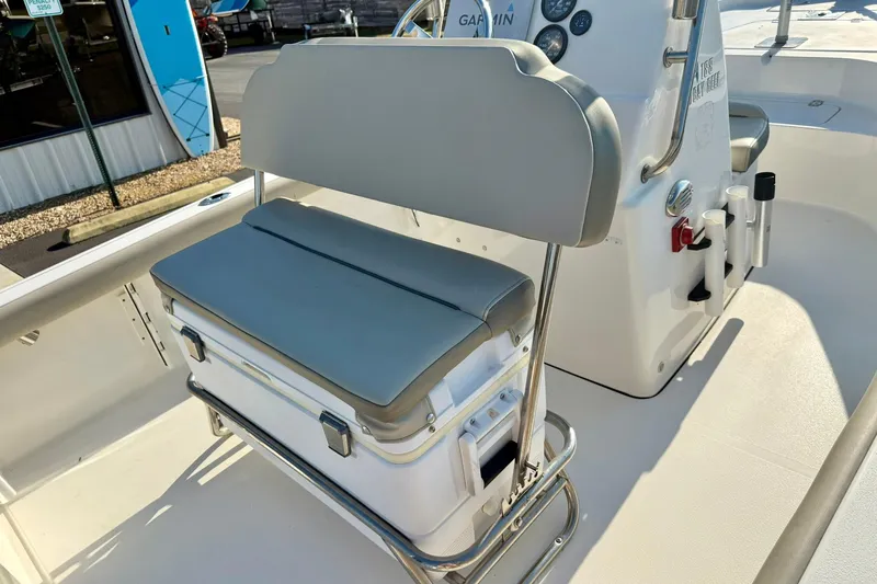 Slide: The Image of 2022 Key West 188 Bay Reef boat interior with cushioned seating and control panel. - 20