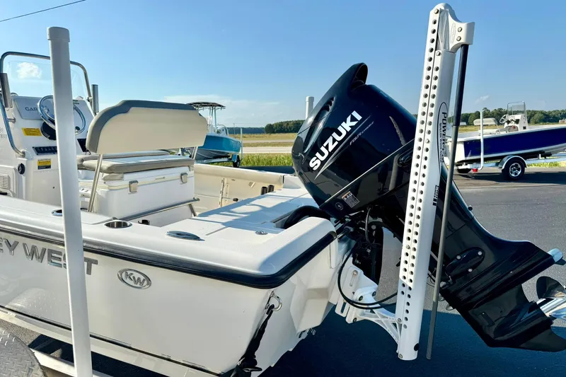 Slide: The Image of 2022 Key West 188 Bay Reef boat with Suzuki outboard motor, parked outdoors. - 33