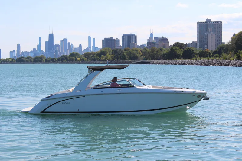The Image of 2016 Cobalt R30 boat cruising on a lake with city skyline in the background. - 0