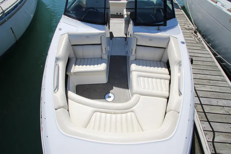 Slide: The Image of 2016 Cobalt R30 boat with spacious white seating, docked at marina. - 13