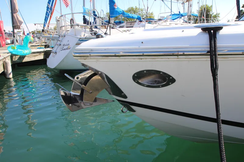 Slide: The Image of 2016 Cobalt R30 boat docked, featuring a stainless steel anchor and calm marina waters. - 2