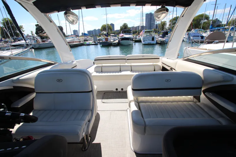 Slide: The Image of 2016 Cobalt R30 boat interior with white seating, docked in a marina. - 21