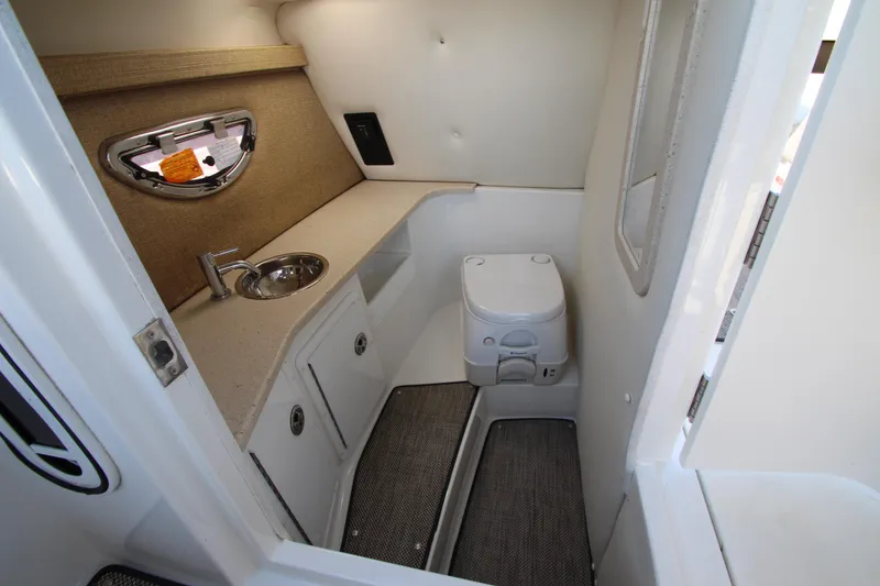 Slide: The Image of 2016 Cobalt R30 boat interior bathroom with sink and toilet. - 23