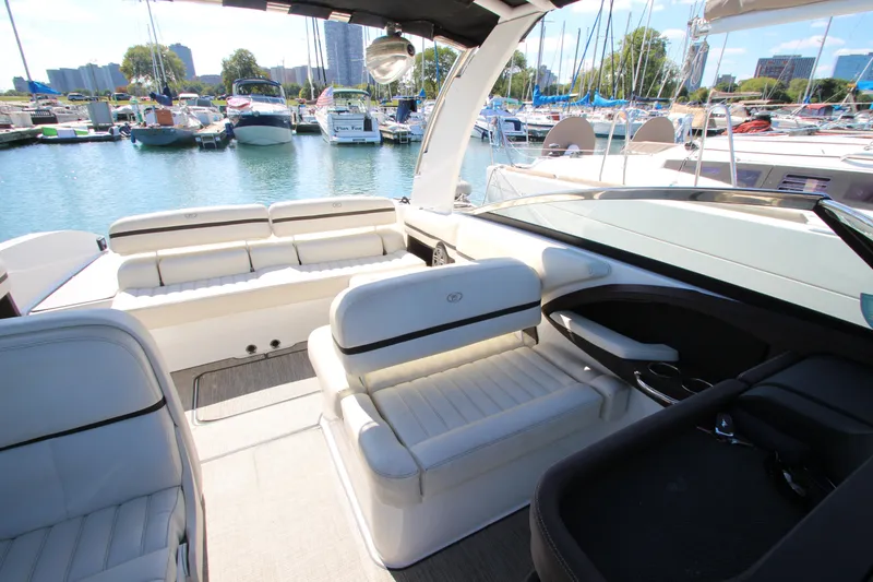 Slide: The Image of 2016 Cobalt R30 boat interior with white seating, docked in a marina. - 25