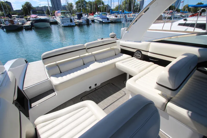 Slide: The Image of 2016 Cobalt R30 boat interior with white seating, docked in a marina. - 31