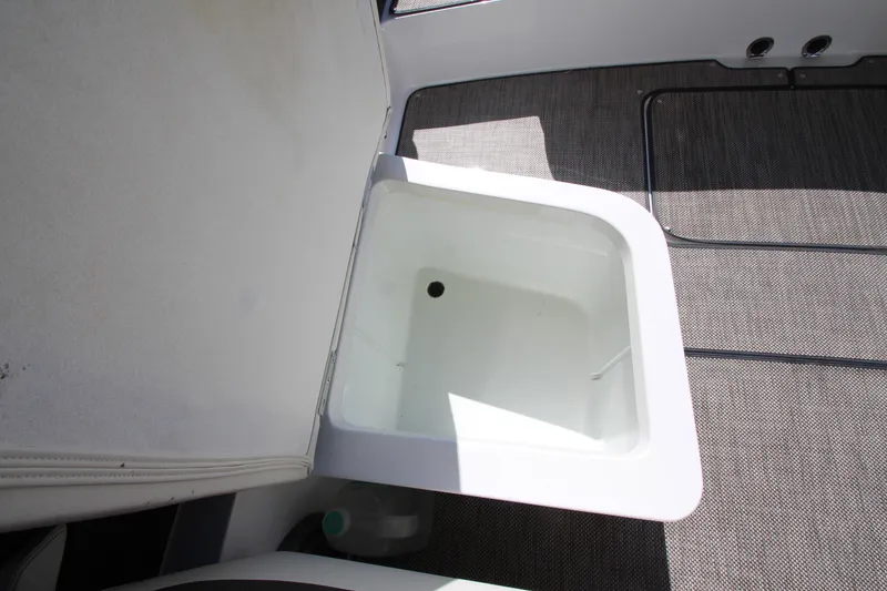 Slide: The Image of Open storage compartment on 2016 Cobalt R30 boat, featuring clean interior and carpeted flooring. - 41