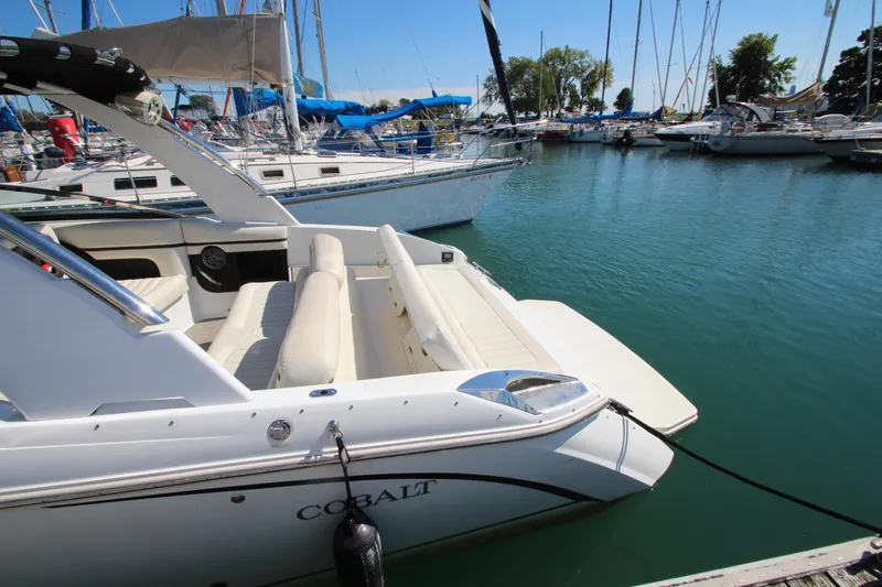 Slide: The Image of Cobalt R30 2016 boat docked in a marina with sailboats in the background. - 8