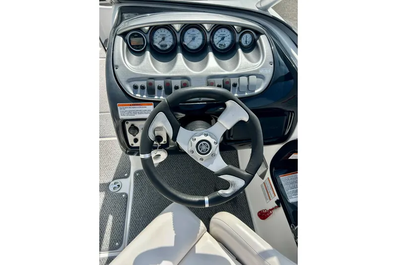 Slide: The Image of Dashboard of a 2008 Yamaha 212X boat with steering wheel and gauges. - 12