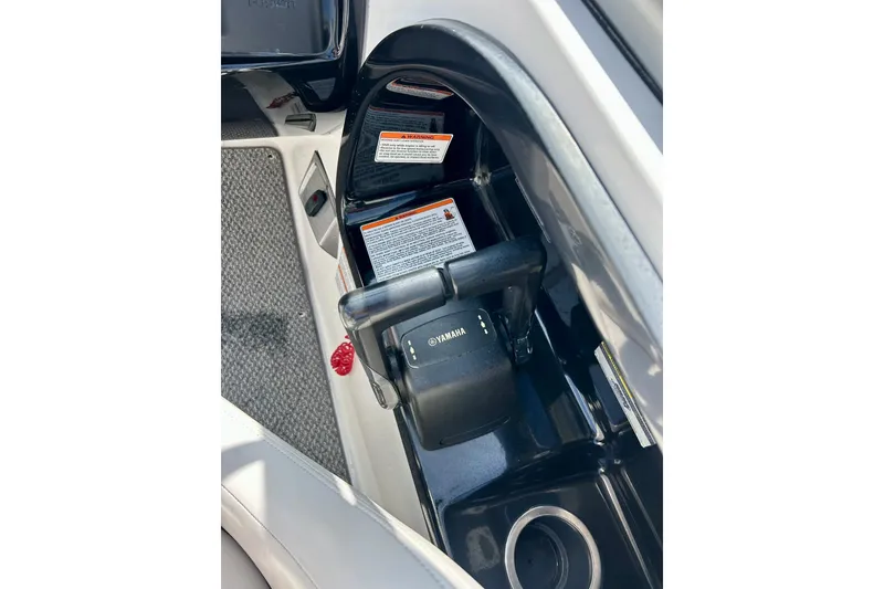 Slide: The Image of 2008 Yamaha 212X boat throttle control with safety instructions and cup holder. - 13