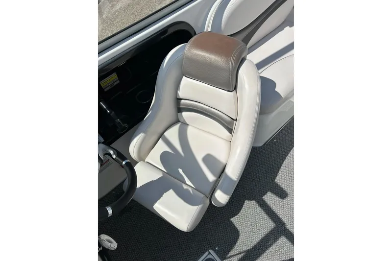 Slide: The Image of 2008 Yamaha 212X boat seat, gray and white upholstery, steering wheel visible. - 15