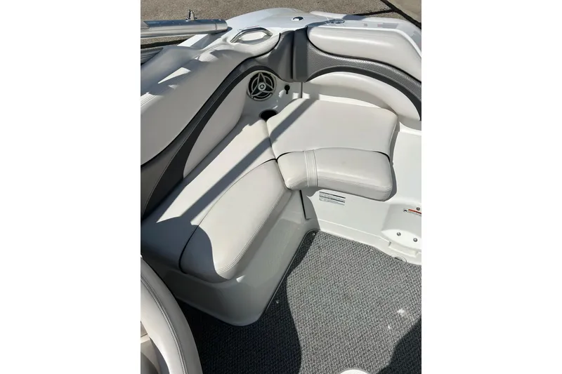 Slide: The Image of Interior seating of 2008 Yamaha 212X boat, featuring white cushioned seats and speaker. - 17