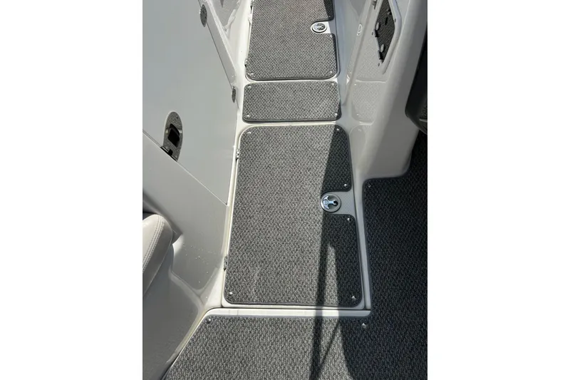 Slide: The Image of Interior view of 2008 Yamaha 212X boat, featuring carpeted flooring and storage compartments. - 29