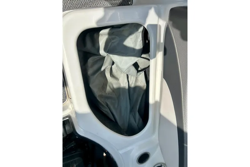 Slide: The Image of Storage compartment in a 2008 Yamaha 212X boat, featuring a gray cover. - 34