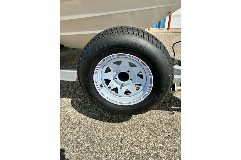 Slide: The Image of Trailer wheel of a 2008 Yamaha 212X boat on a sunny day. - 4