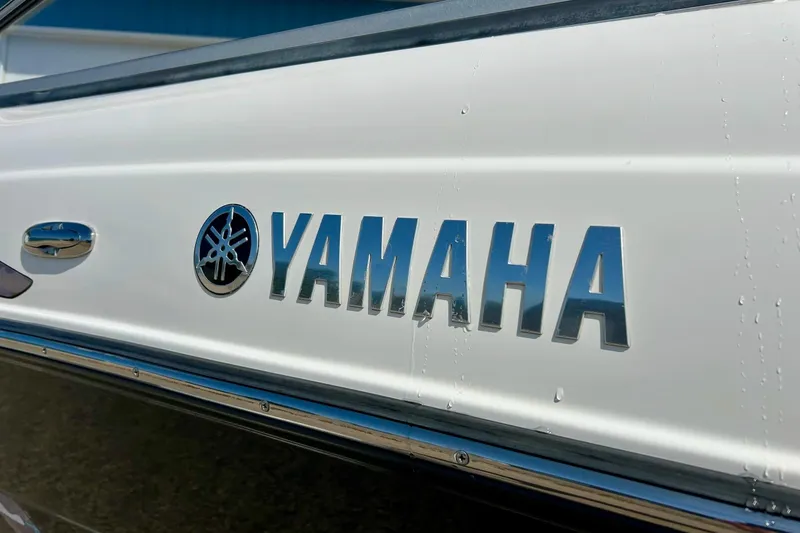 Slide: The Image of Close-up of 2008 Yamaha 212X boat logo on white surface. - 6