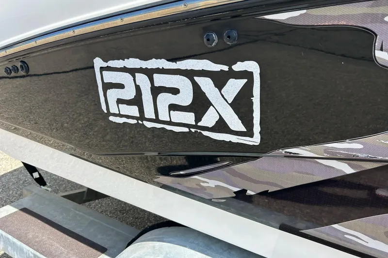 Slide: The Image of 2008 Yamaha 212X boat logo on sleek black hull. - 7