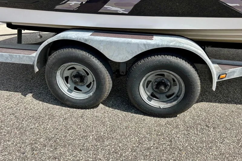 Slide: The Image of Trailer wheels of a 2008 Yamaha 212X boat on asphalt surface. - 9