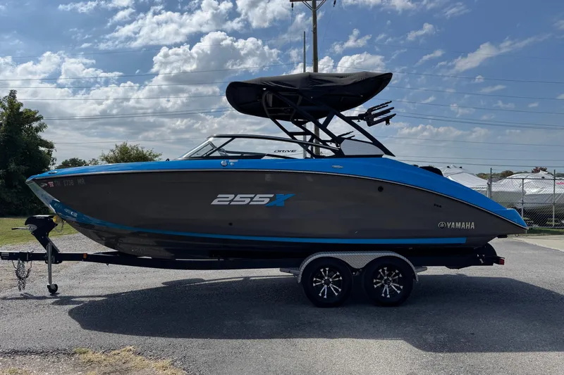 Slide: The Image of 2022 Yamaha Boats 255XD on trailer, sleek design, blue and black color scheme. - 3