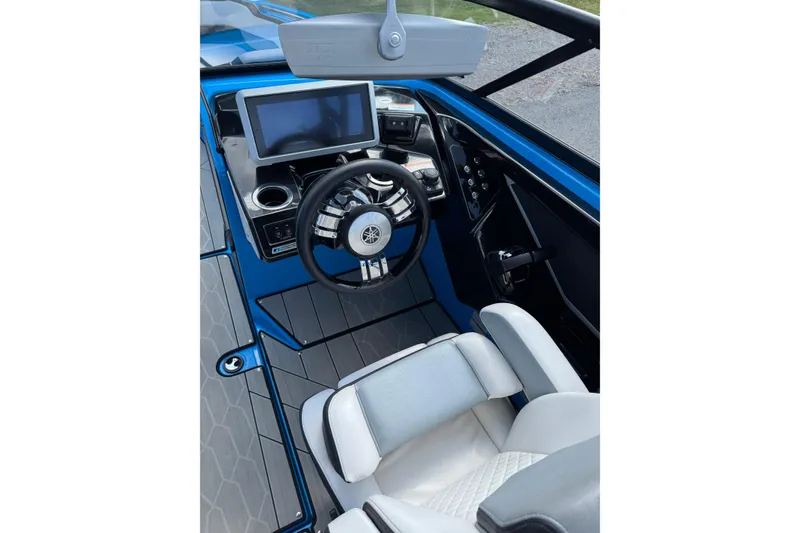 Slide: The Image of Interior of 2022 Yamaha Boats 255XD, featuring modern steering and dashboard controls. - 5