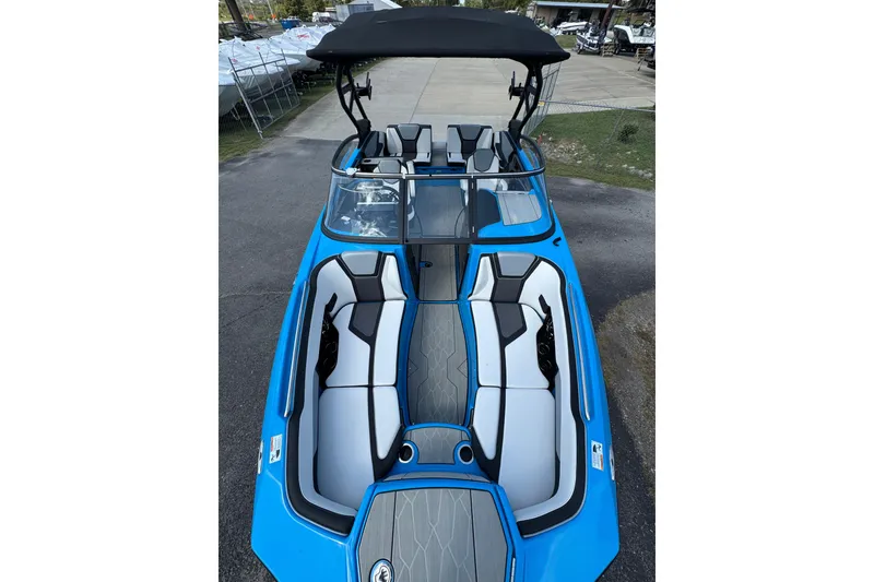 Slide: The Image of 2022 Yamaha Boats 255XD, blue exterior, spacious seating, sleek design, docked outdoors. - 6