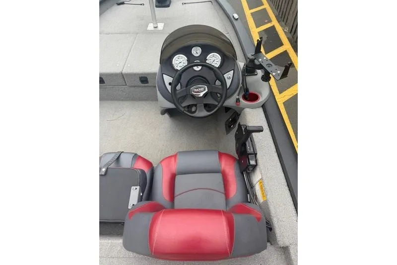 Slide: The Image of 2008 Tracker Pro Team 175 TXW boat interior with steering wheel and red-gray seating. - 4