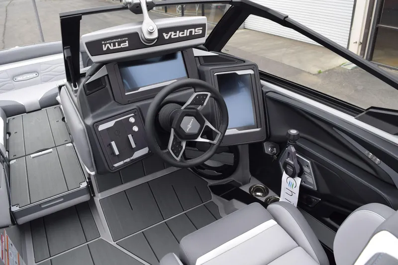 Slide: The Image of 2025 Supra SA boat interior with modern dashboard, touchscreen displays, and sleek steering wheel design. - 3