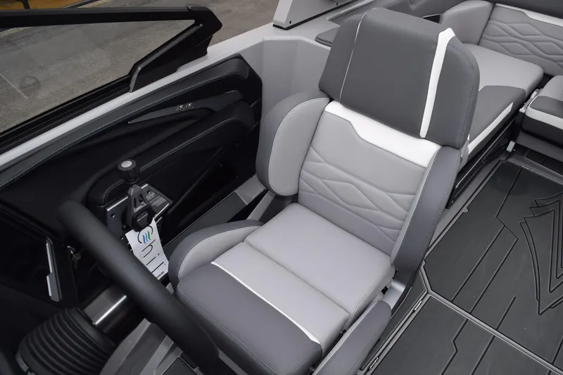 Slide: The Image of 2025 Supra SA boat interior with gray and white seating and modern controls. - 4