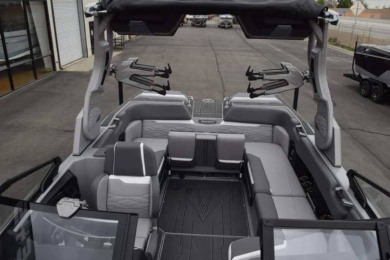 Slide: The Image of 2025 Supra SA boat interior with gray seating and advanced wakeboard racks. - 6