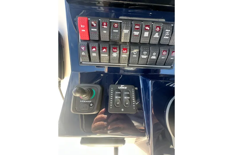 Slide: The Image of Control panel of 2024 Pursuit S 288 Sport boat with switches and joystick. - 13