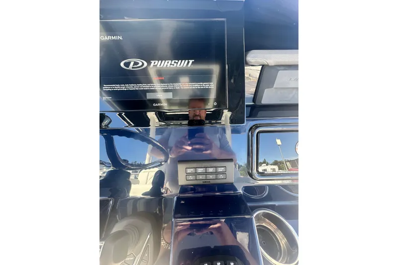 Slide: The Image of 2024 Pursuit S 288 Sport dashboard with Garmin display and controls. - 14