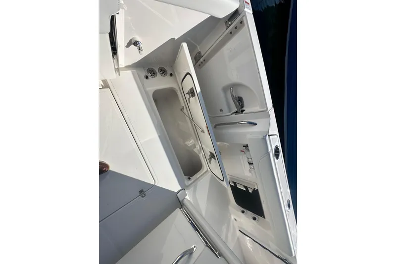 Slide: The Image of 2024 Pursuit S 288 Sport boat interior with open storage compartments. - 20