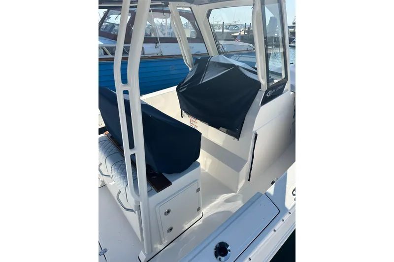 Slide: The Image of 2024 Pursuit S 288 Sport boat interior with covered seating and helm station. - 4