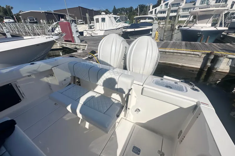 Slide: The Image of 2024 Pursuit S 288 Sport boat docked, featuring dual Yamaha engines and spacious seating. - 9