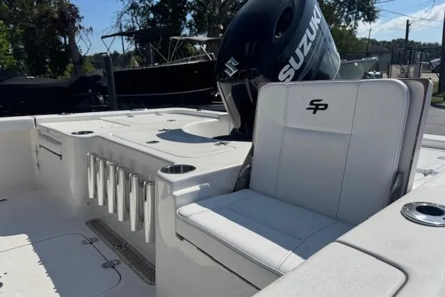 Slide: The Image of 2024 Sea Pro 210 Bay boat interior with Suzuki engine and seating. - 13